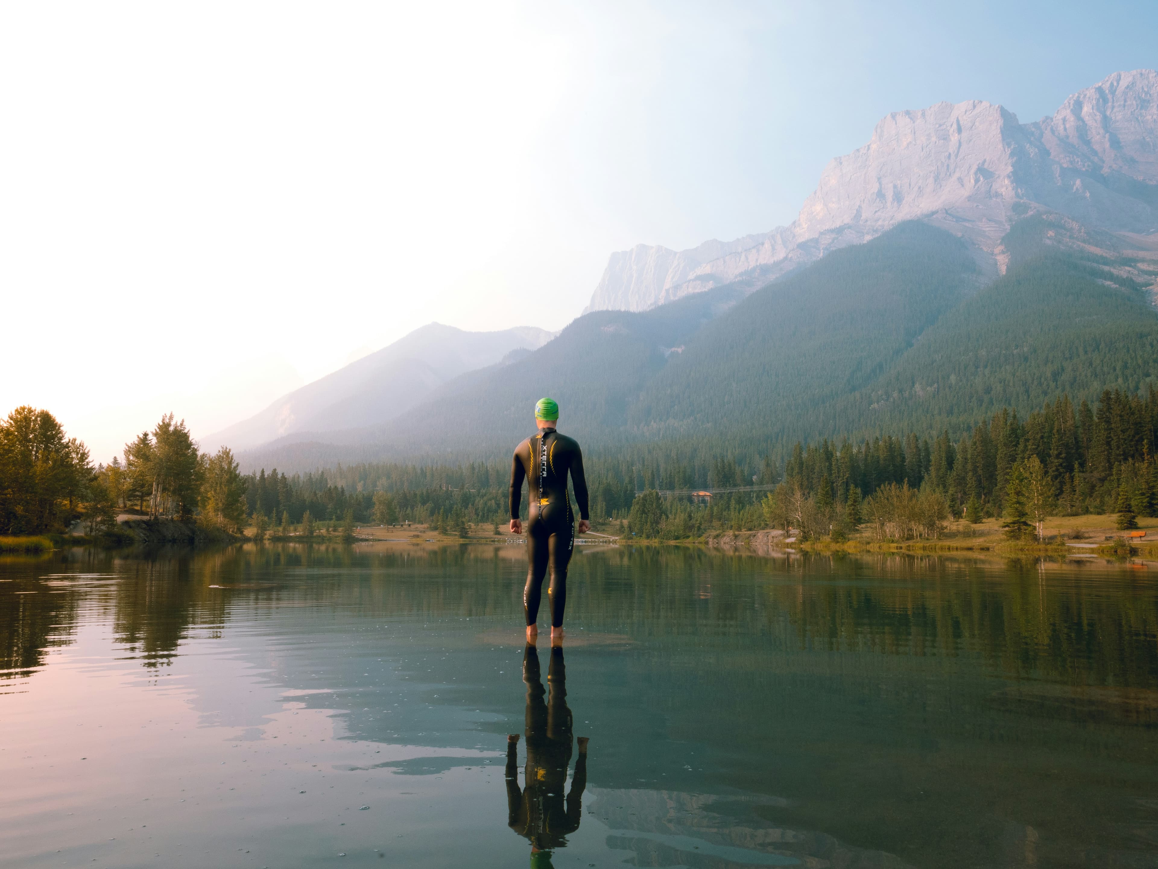 An athlete by a lake at sunrise